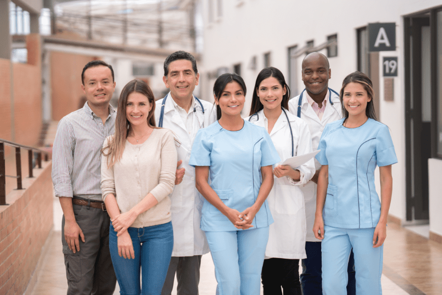 The staff of a medical practice pose for a group photograph.