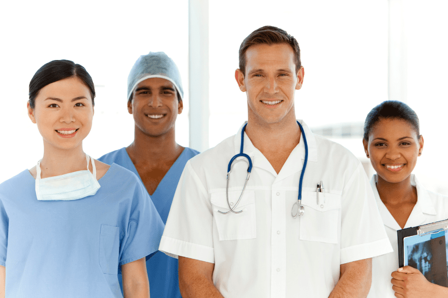 Four medical professionals pose for a photograph at their medical practice.